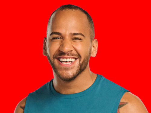 A headshot of Peloton Instructor Jeffrey Mc Eachern on a red backdrop