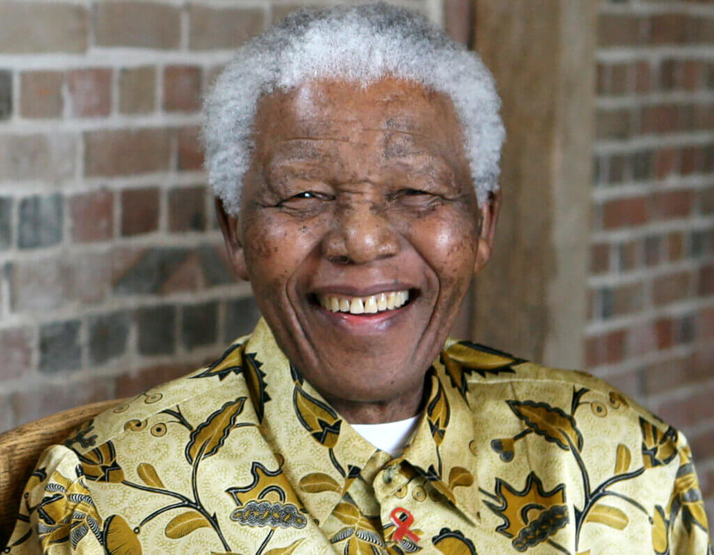 Late South African president Nelson Mandela smiles as he poses for a portrait during an event in London.