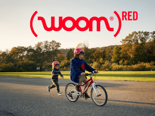 children riding lightweight (woom)ᴿᴱᴰ bicycle with woom logo